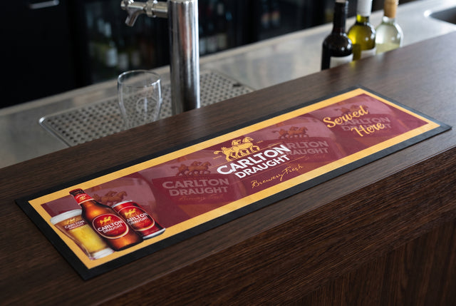 Carlton Draught Premium Rubber-Backed Bar Mat Runner on a bar top