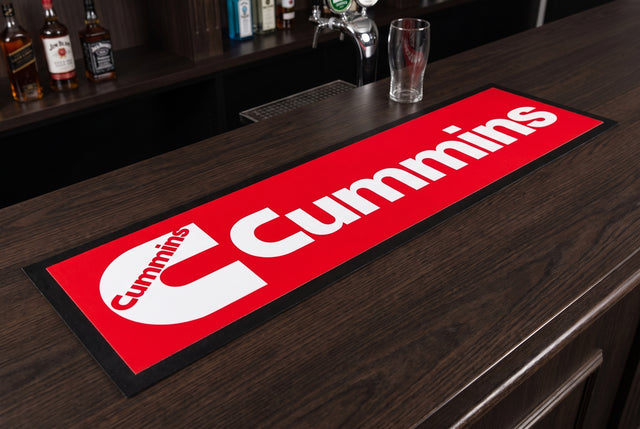 Cummins Red Premium Rubber-Backed Bar Mat Runner on a bar top