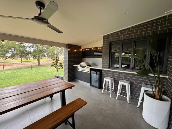 Covered alfresco area with a built-in barbecue and a Schmick HUS-EX108 glass door bar fridge under the benchtop
