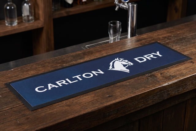 Carlton Dry Dark Premium Rubber-Backed Bar Runner on a bar top