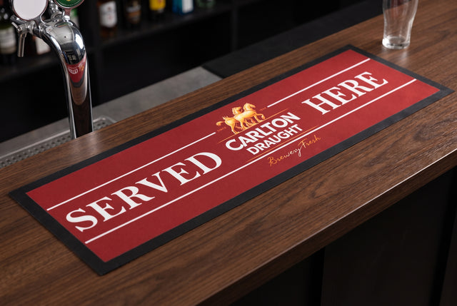Carlton Draught Served Here Premium Rubber-Backed Bar Runner on a bar top