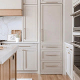 Schmick MSL330 integrated upright fridge hidden behind matching cabinetry in a modern kitchen, door closed