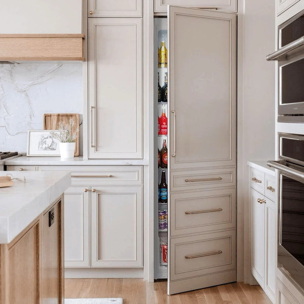 Schmick MSL330 integrated upright fridge behind cabinetry in a modern kitchen, door open showing the stocked shelves inside