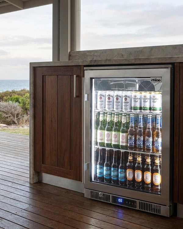 Rhino ENV outdoor bar fridge built into timber outdoor kitchen cabinetry on the covered deck of an Australian coastal house