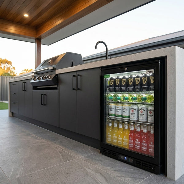 Rhino SG1 Black HD bar fridge under a stone benchtop beside a matte black BBQ and black tapware in a roofed alfresco kitchen