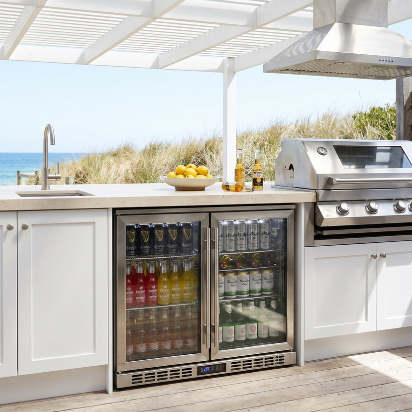 Rhino SG2H-HD bar fridge built into an outdoor kitchen: coastal alfresco kitchen under a white pergola, stainless bbq and rangehood