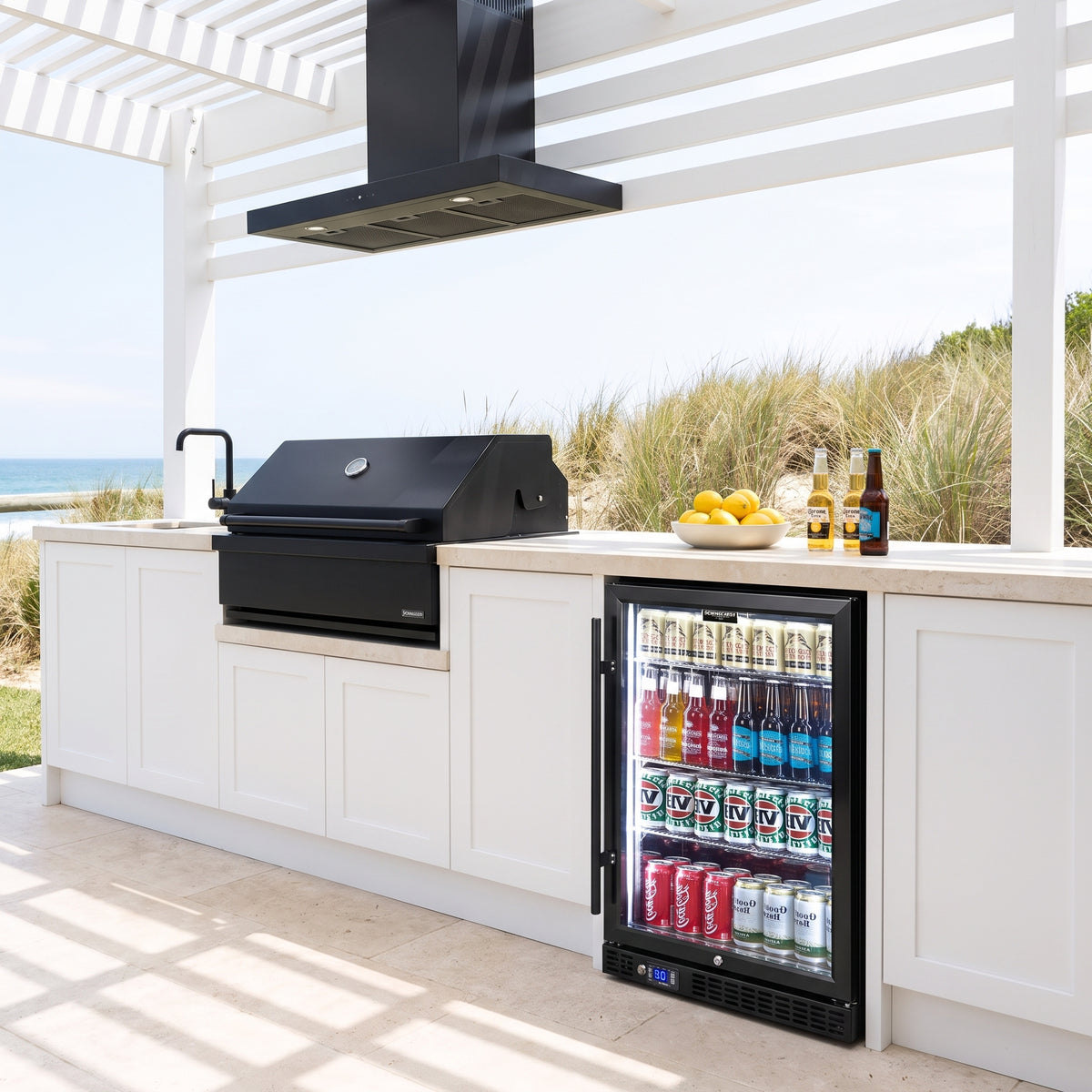 Schmick SK146L-B-HD bar fridge built into an outdoor kitchen: coastal alfresco kitchen under a white pergola, black bbq and rangehood
