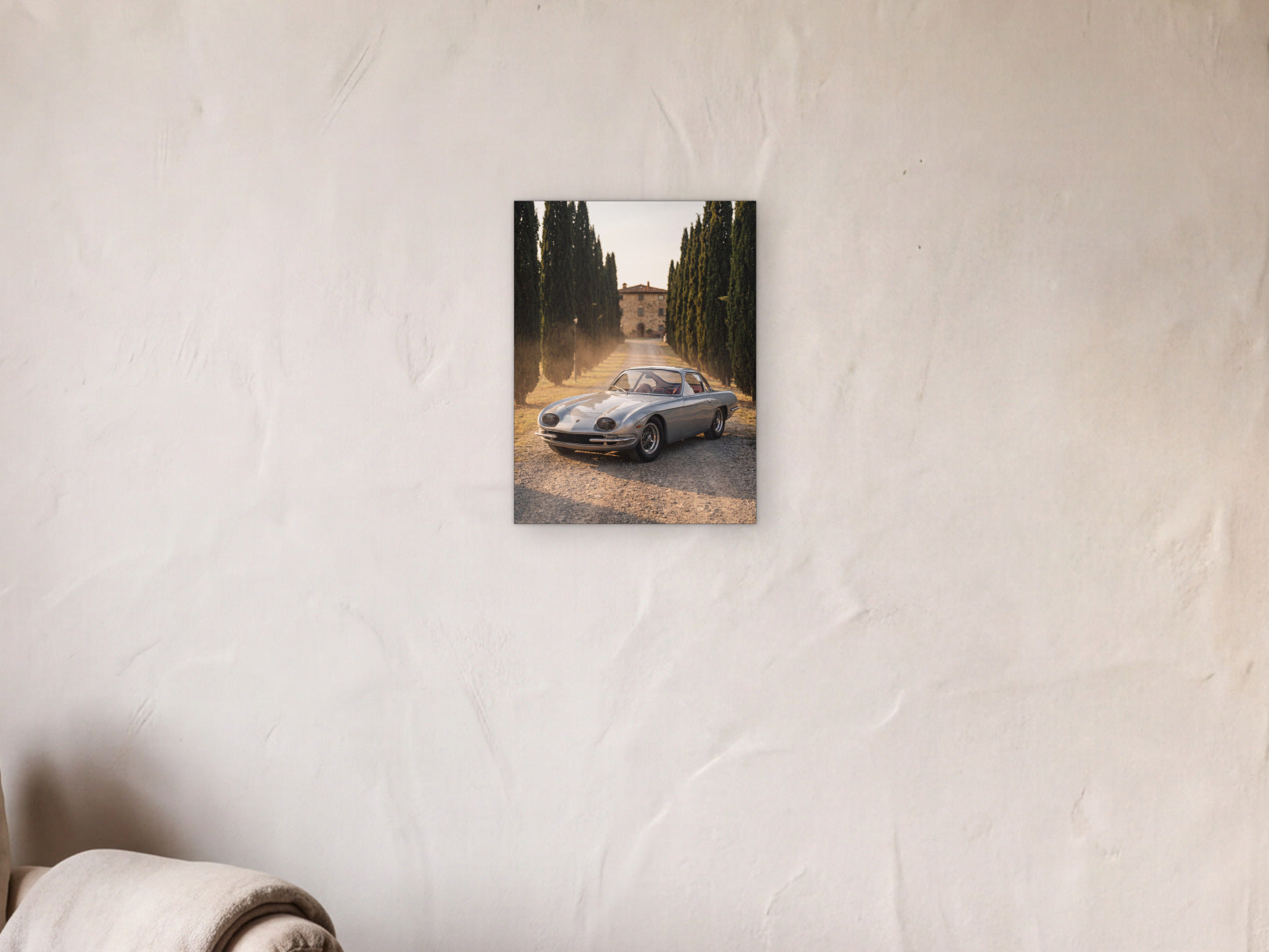 Lamborghini 350 GT - Cypress Avenue shown in a limewash reading corner beside an armchair and a floor lamp - scale render at 30 x 40 cm