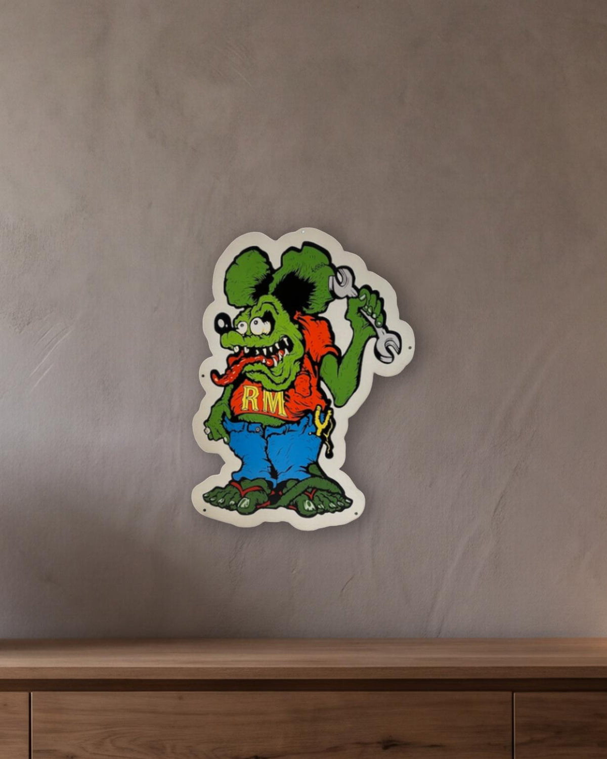 Rat Fink Mechanic Retro Metal Sign - 430 x 600mm shown in a room with a long oak sideboard - scale render at 430 x 600mm