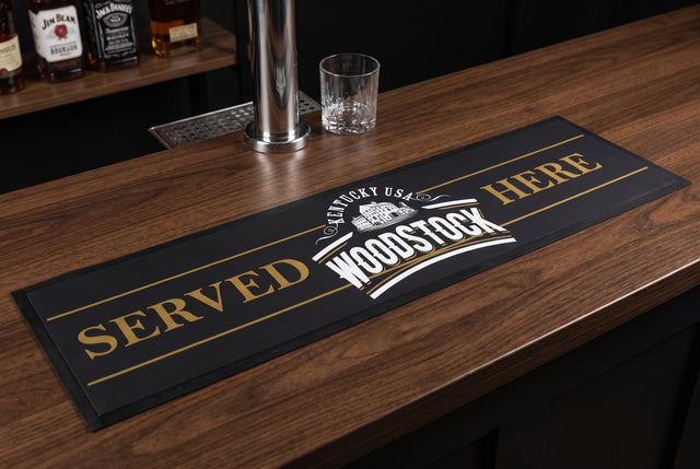 Woodstock Bourbon Premium Rubber-Backed Bar Mat Runner on a bar top