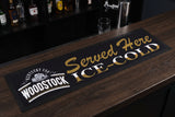 Woodstock "Served Here Ice Cold" Premium Rubber-Backed Bar Runner on a bar top
