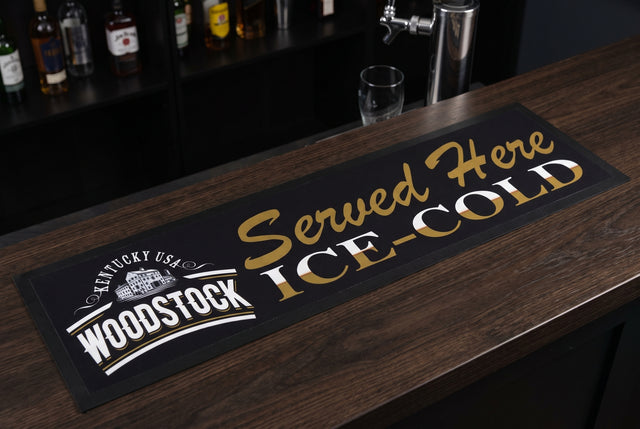 Woodstock "Served Here Ice Cold" Premium Rubber-Backed Bar Runner on a bar top
