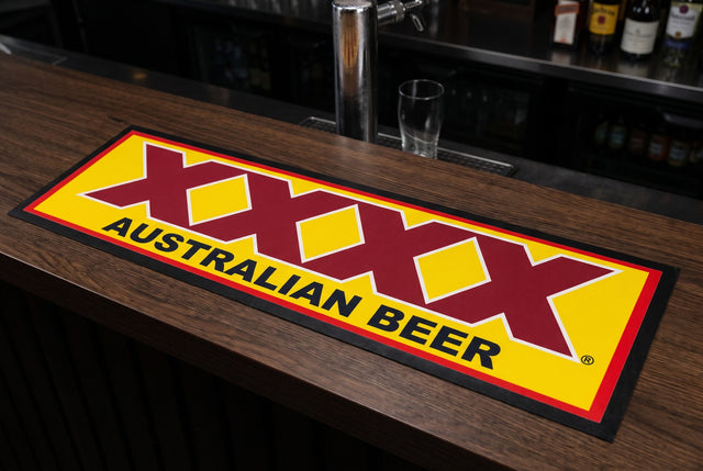 XXXX Australian Beer Premium Rubber-Backed Bar Mat Runner on a bar top